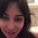 From under the toilet, a very cute girl pushes out a couple of thick logs that hang and drop into the bowl, followed by the product. Filmed from a between the legs perspective. Vertical format video. Over a minute.